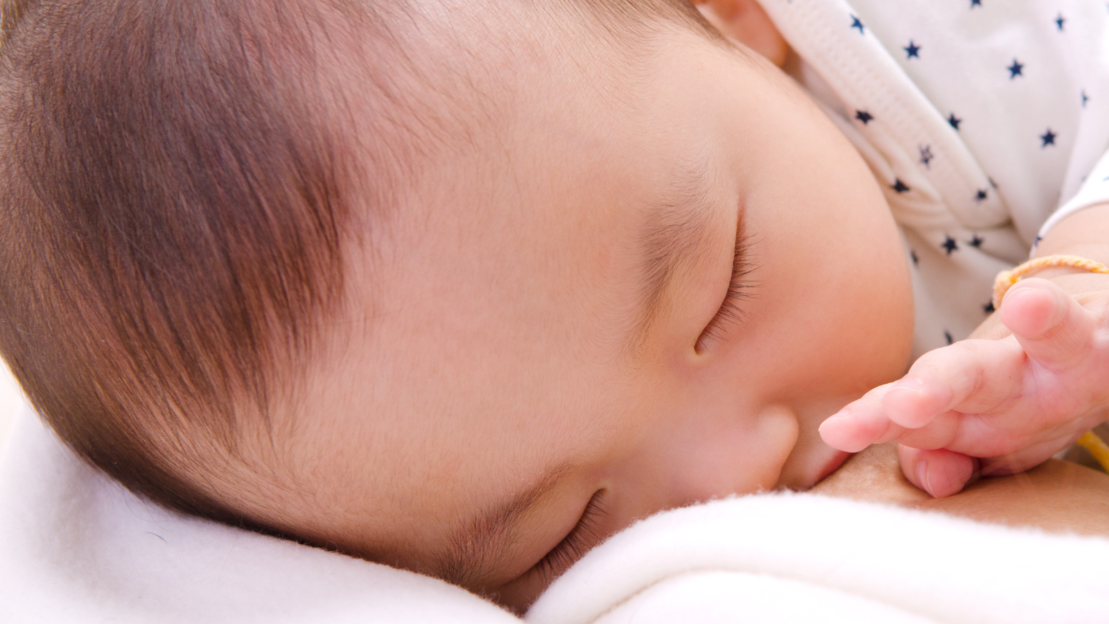 Close up photo of breastfeeding baby.